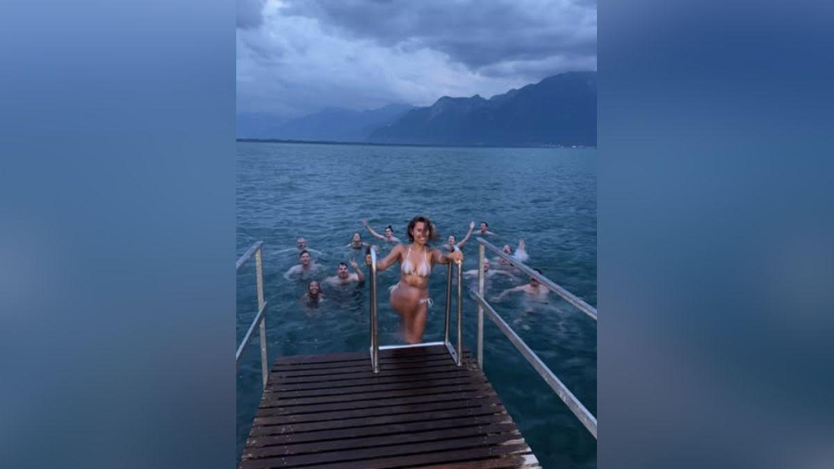 Image of Raye took a dip in Lake Geneva while in Switzerland. 