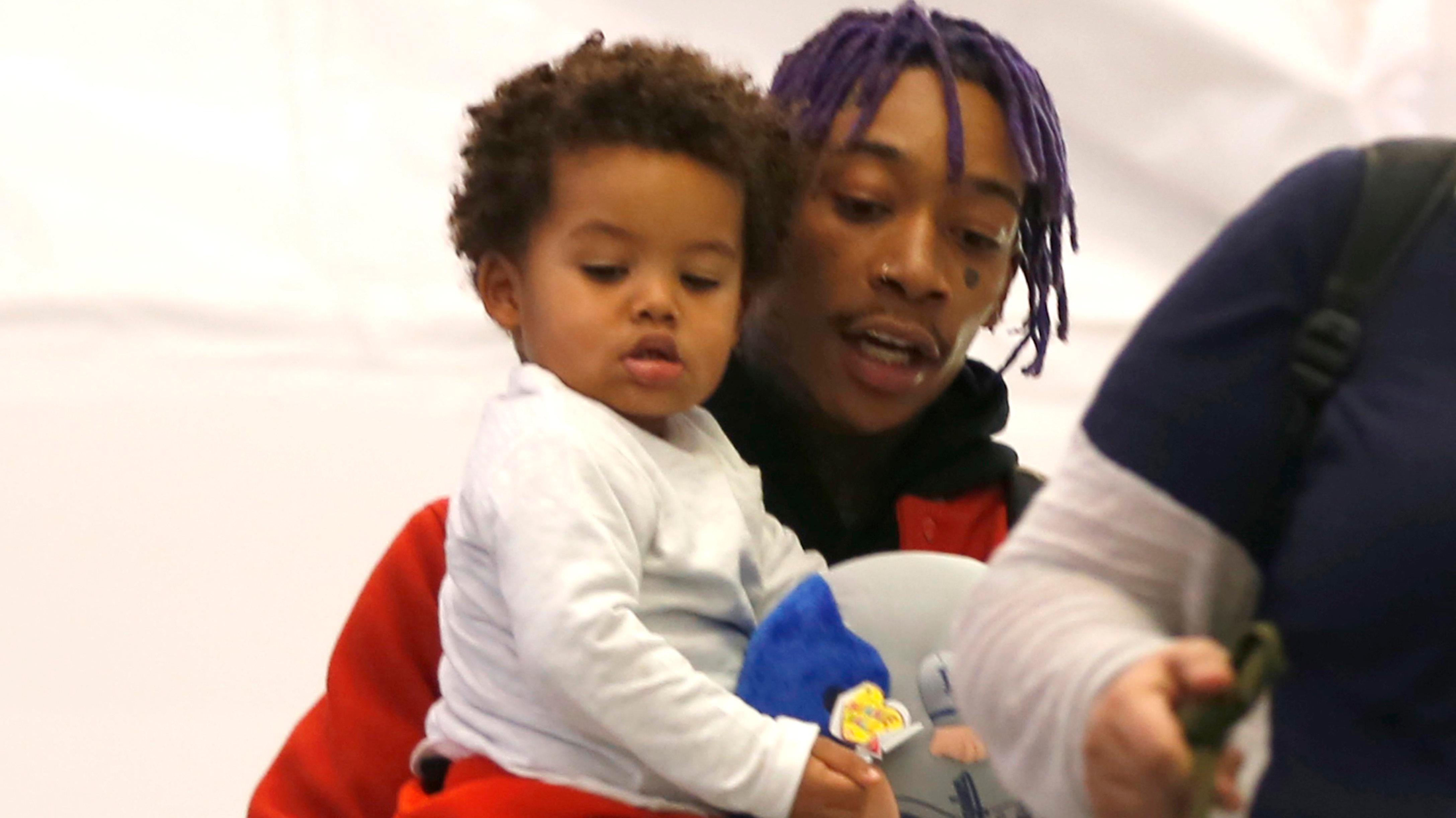 EXCLUSIVE: Rapper, Wiz Khalifa spotted holding his adorable son, Sebastian Taylor Thomaz as they arrive in Los Angeles