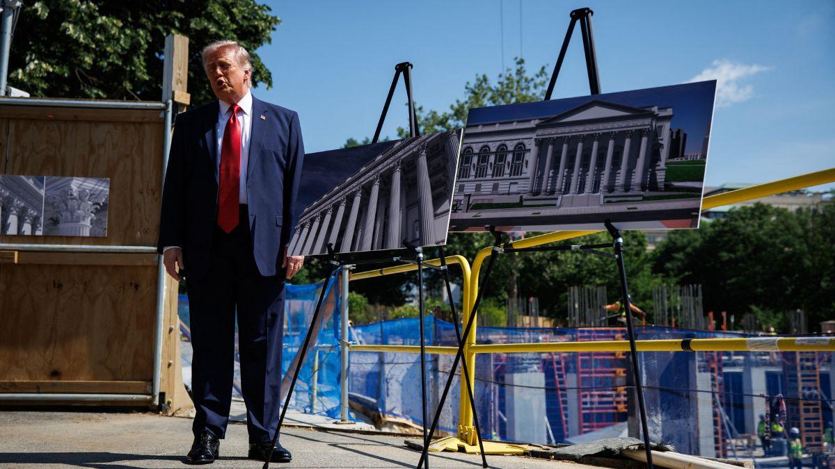 Photo of The president said he was holding a poster so the press didn't 'have to look at my waist.'
