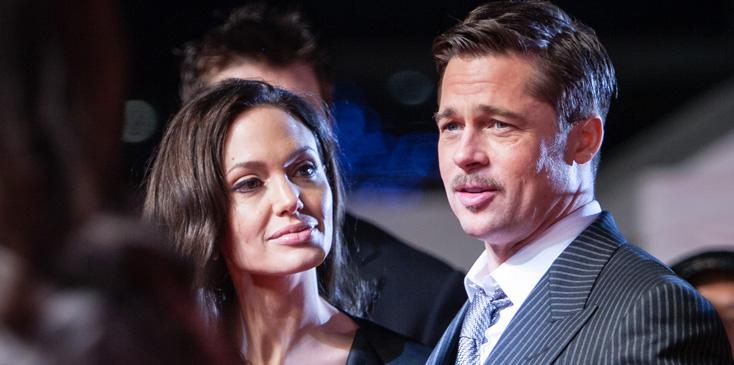 (FILE PHOTO) Brad Pitt and Angelina Jolie on red carpet in Japan