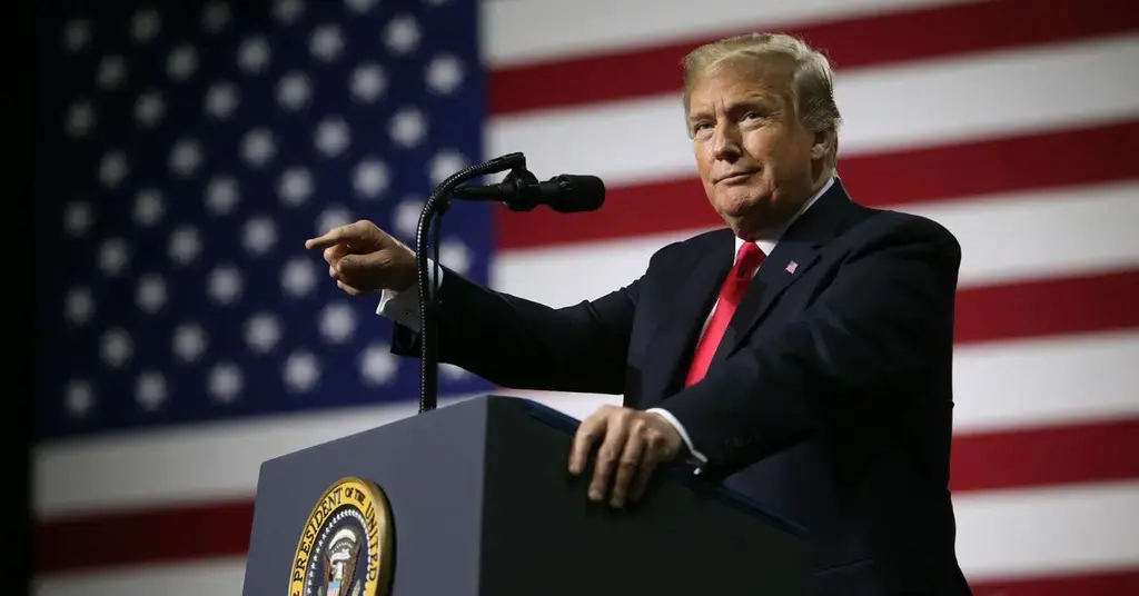 Donald Trump speaking in front of a giant American flag