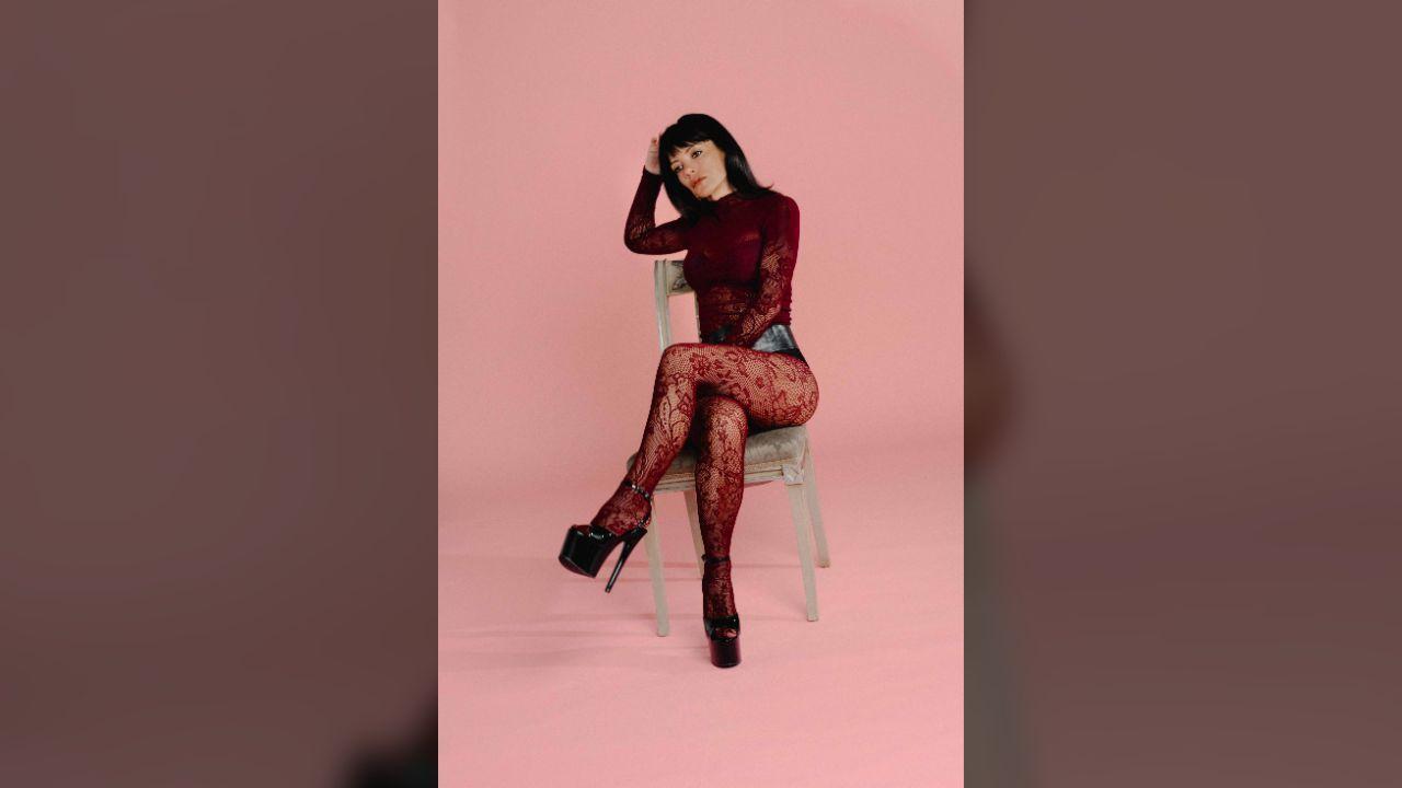 Image of Lily Allen finished the campaign's retro-inspired lineup with burgundy lace ensemble and towering black platforms.