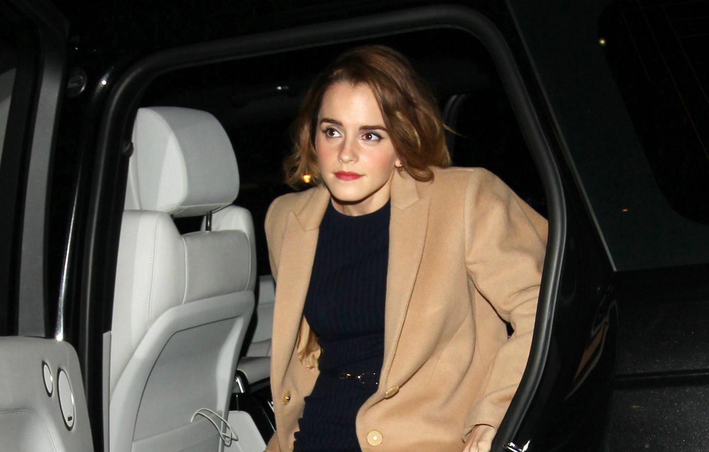 Emma Watson in a beige coat and black dress