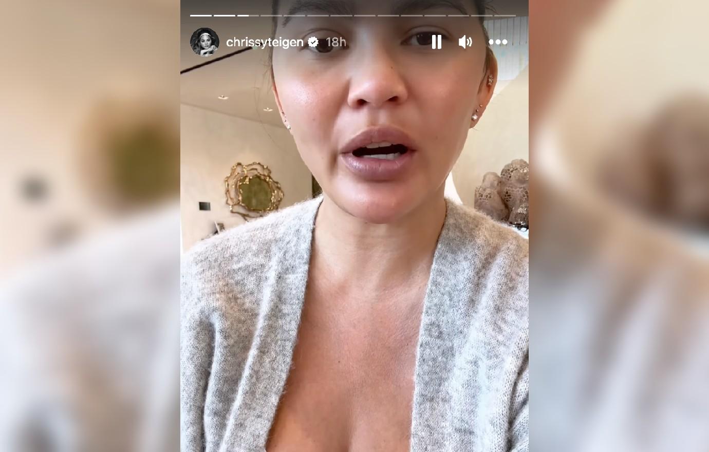 Chrissy Teigen flaunts MAJOR cleavage struggling to squeeze into