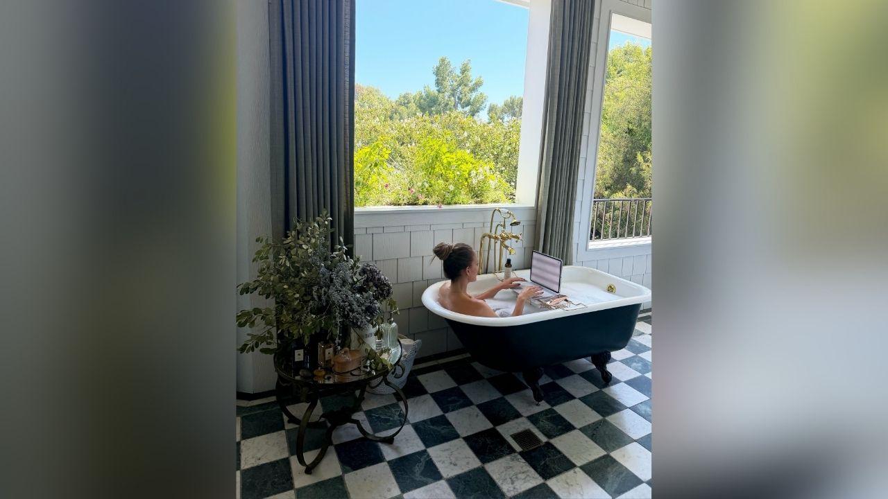 image of Jennifer Lopez recently shared a photo of herself working on a laptop while relaxing in a luxurious bathtub.