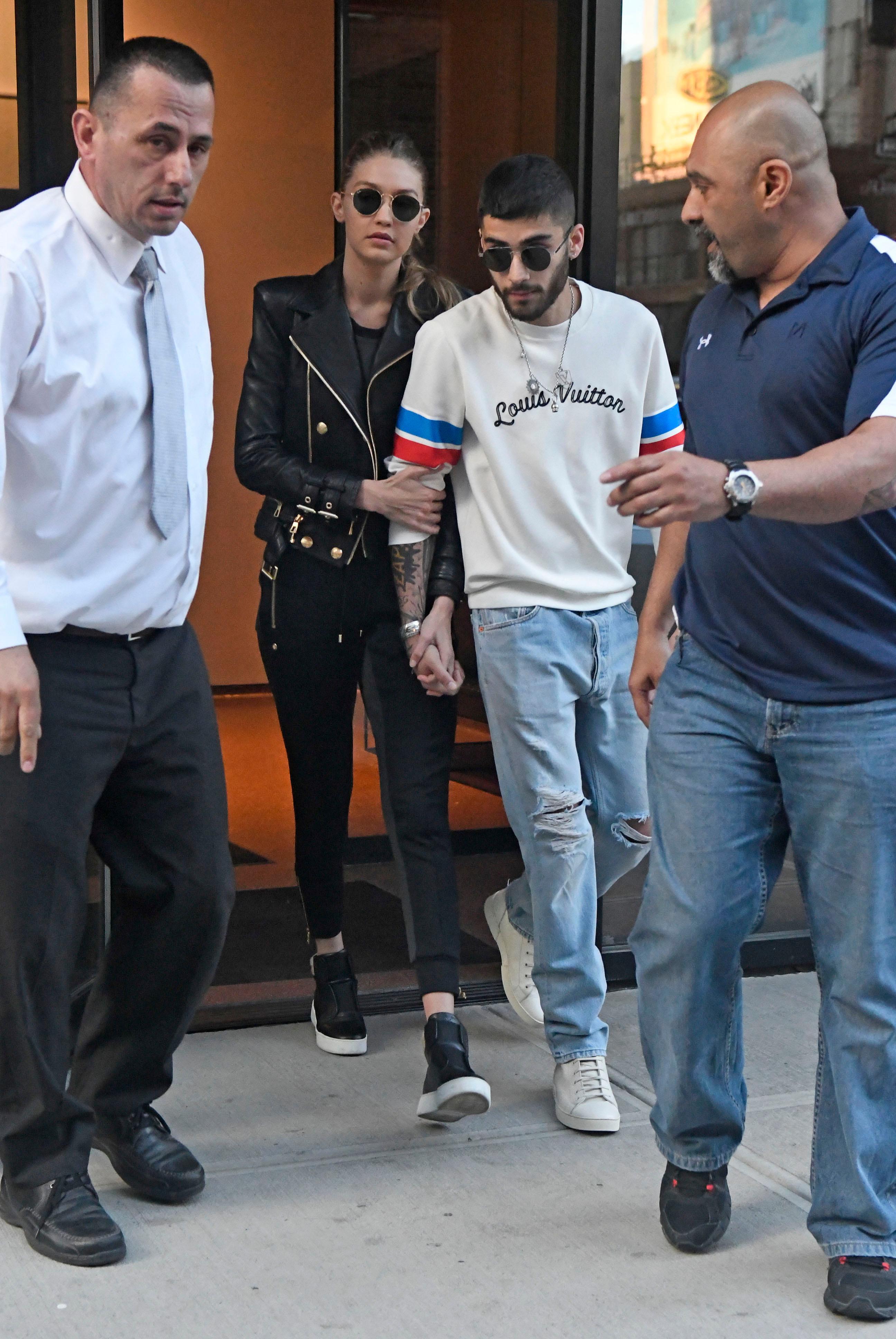 Gigi Hadid and Zayn Malik hold hands while exiting their apartment in NoHo in New York City