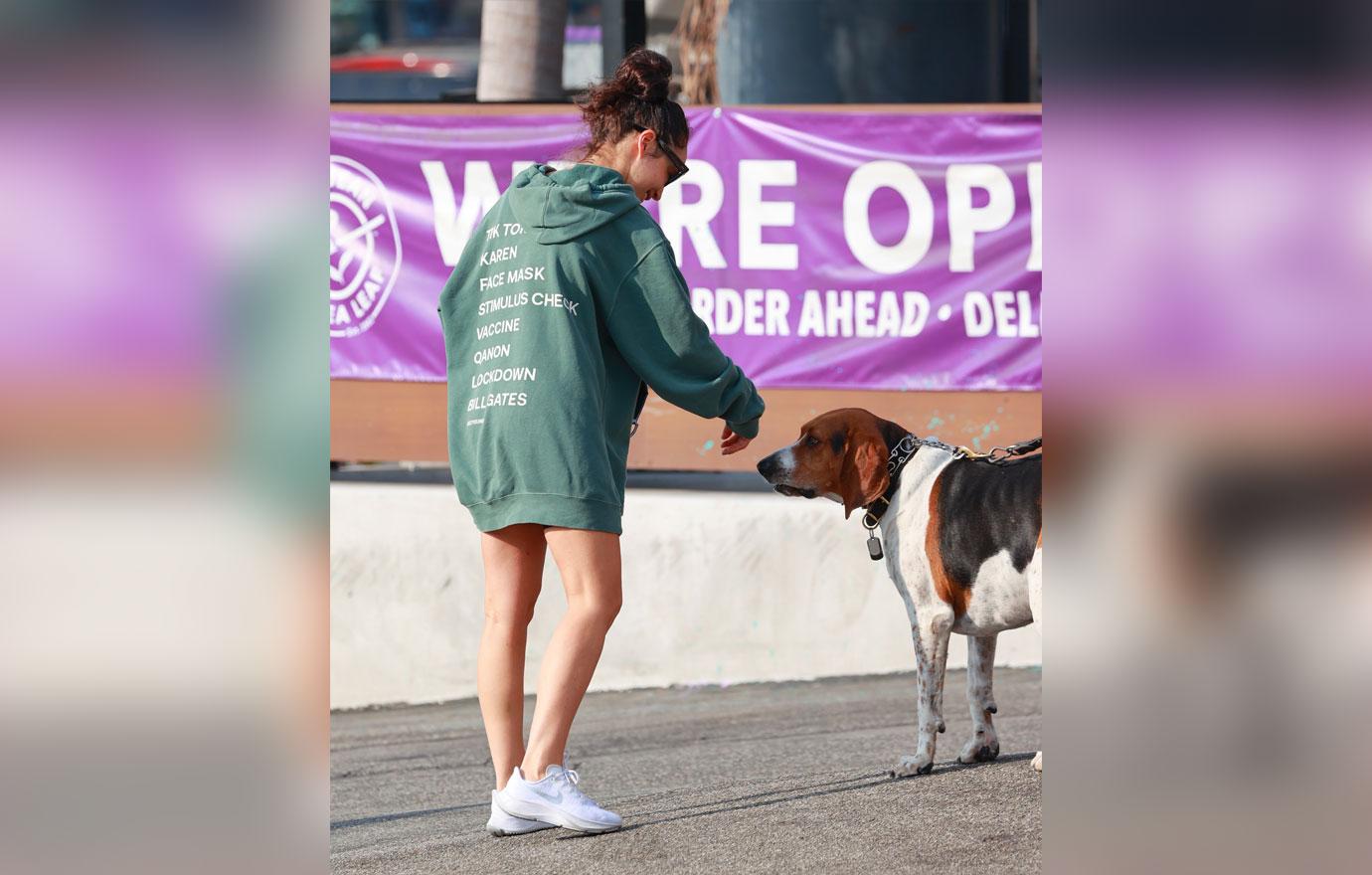 Cara Santana rocks a “see you in ‘21” Hoodie as she grabs an iced coffee after the gym. The top Made by Thirty Seconds of Mars