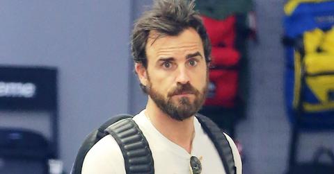 Justin Theroux looks at some sneakers in a boutique Soho store