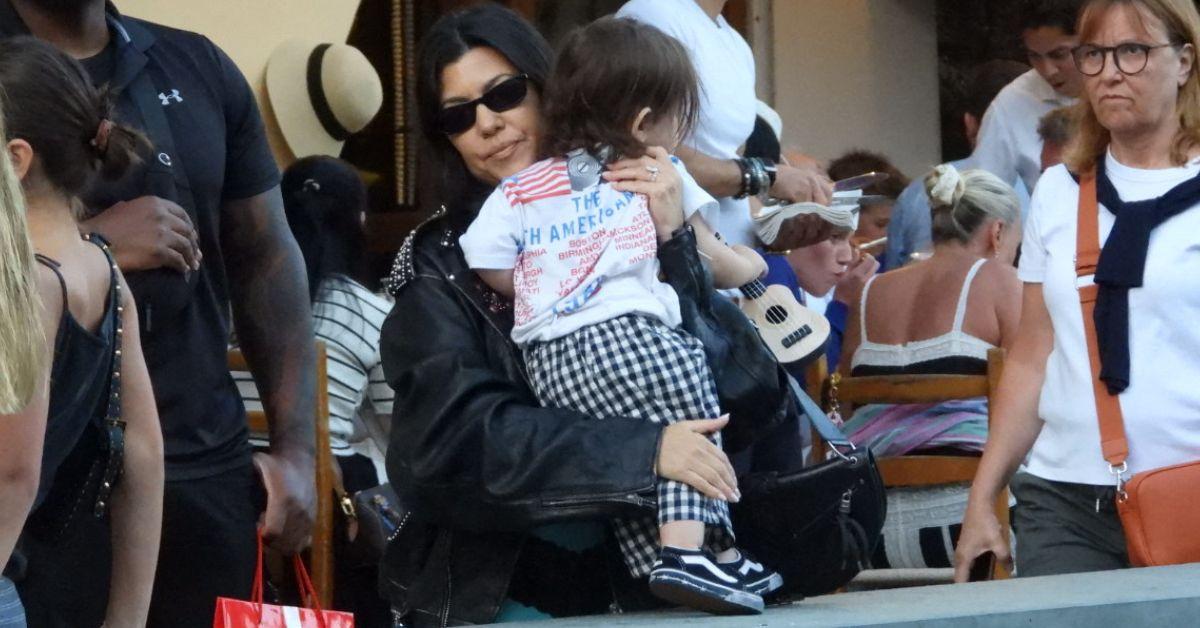 image of Kourtney Kardashian held onto her toddler while vacationing in Portofino, Italy on July 9.