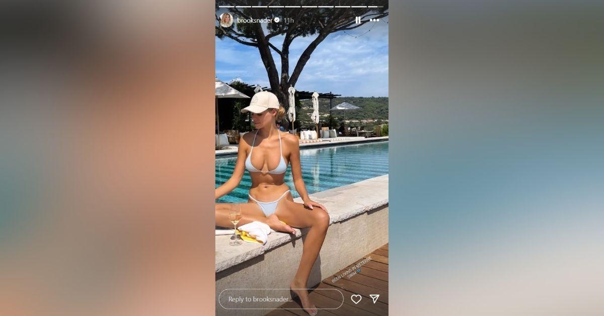 image of The model wore a blue micro bikini by the pool.