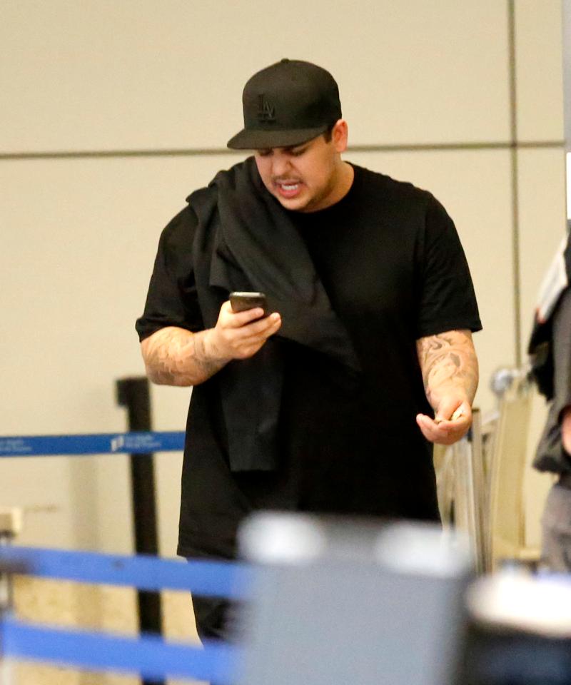 Rob Kardashian skips his sister&#8217;s wedding amidst reports there was a family clash as he is seen at LAX on the same day Kim Kardashian is due to get married to Kanye West at the Palace of Versailles