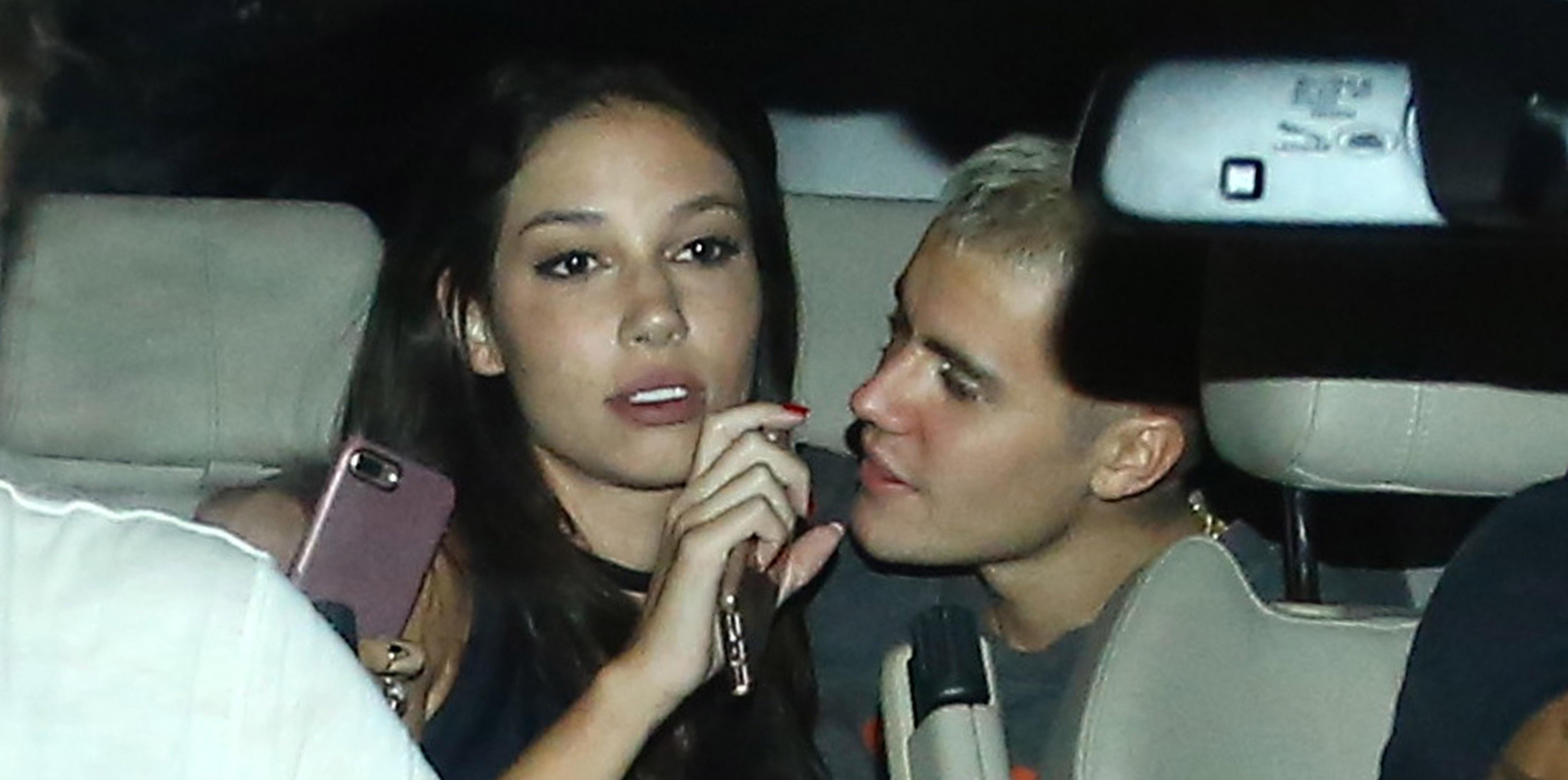 *EXCLUSIVE* Justin Bieber gets cozy with a girl as he exits his Rio hotel