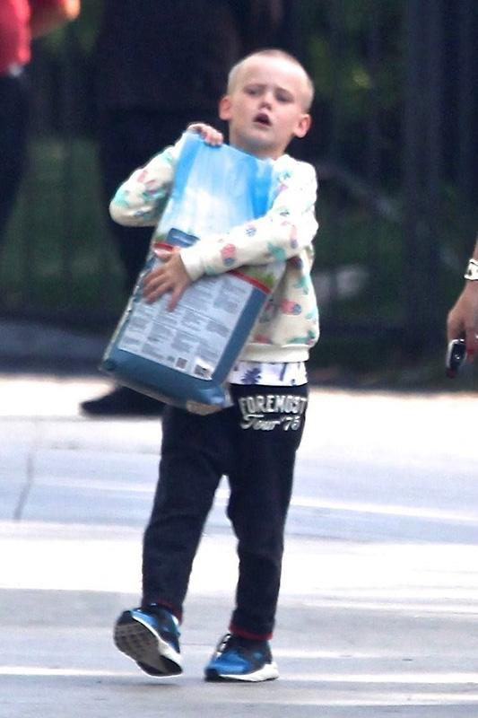 *EXCLUSIVE* Hilary Duff gets some help from Luca carrying the dog food