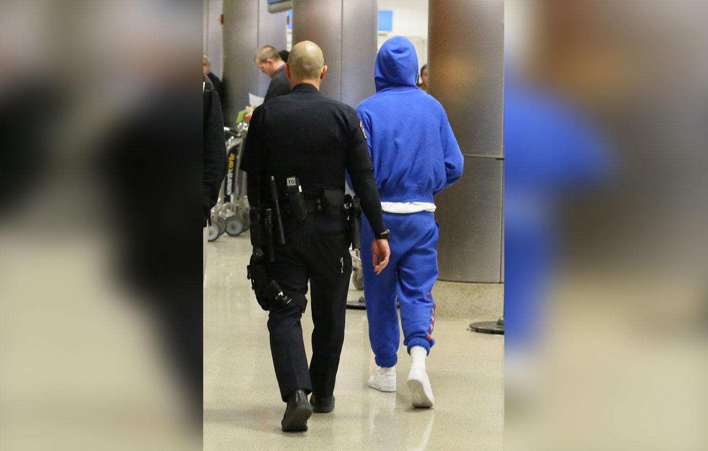 Louis Tomlinson airport arrest blue hoodie 07