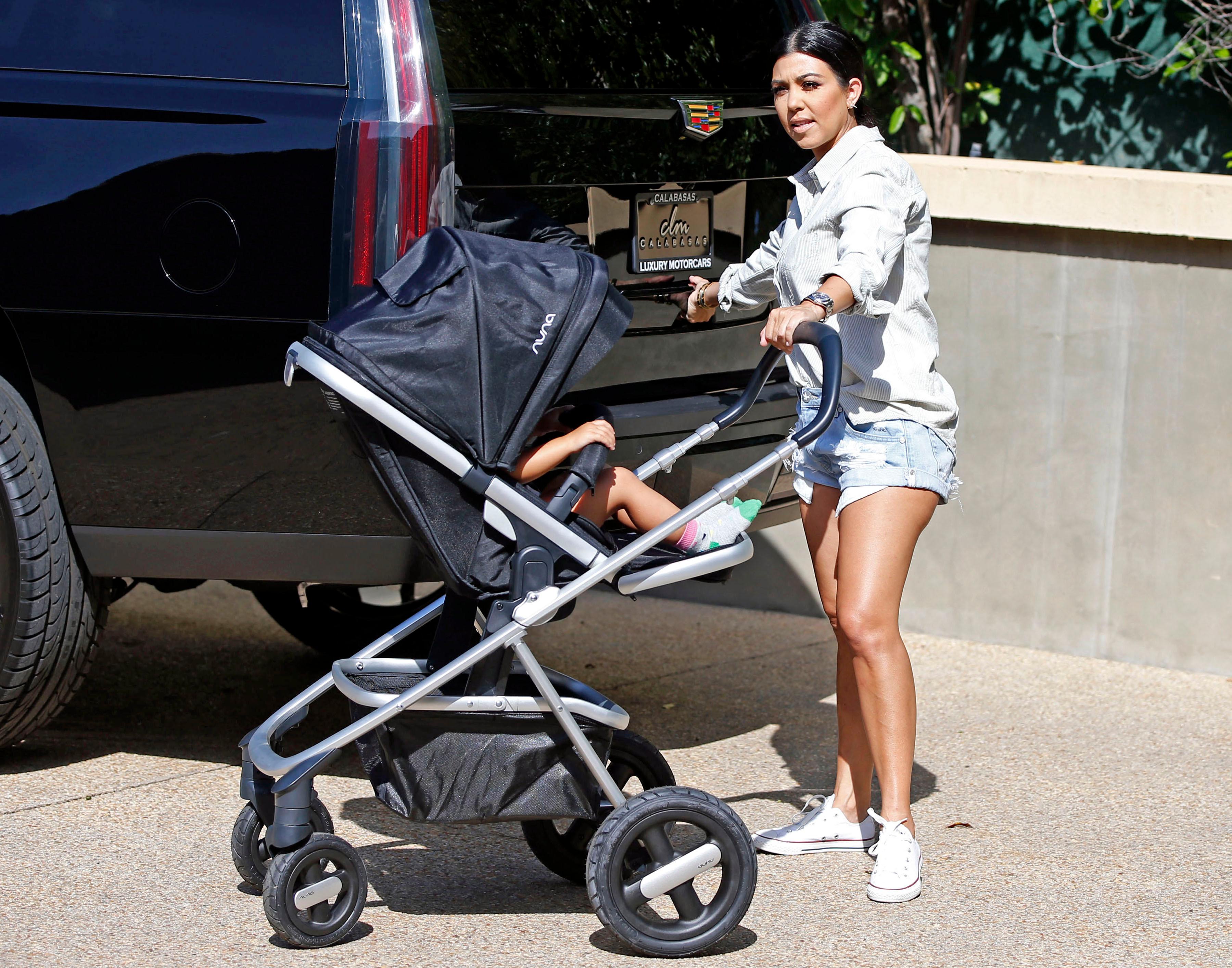 EXCLUSIVE: Kourtney Kardashian taking in a few mommy moments while running some post Mothers Day errands with her Nuna stroller in Calabassas on May 11, 2015