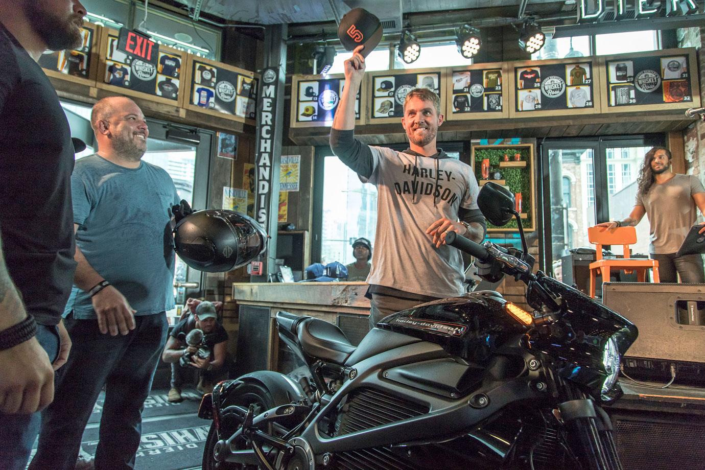 Brett Young greets fans ahead of his private set at Whiskey Row on a Harley-Davidson LiveWire