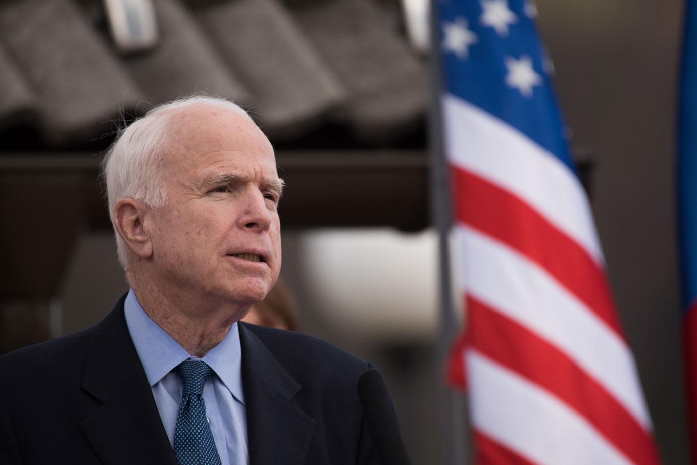 John mccain near american flag