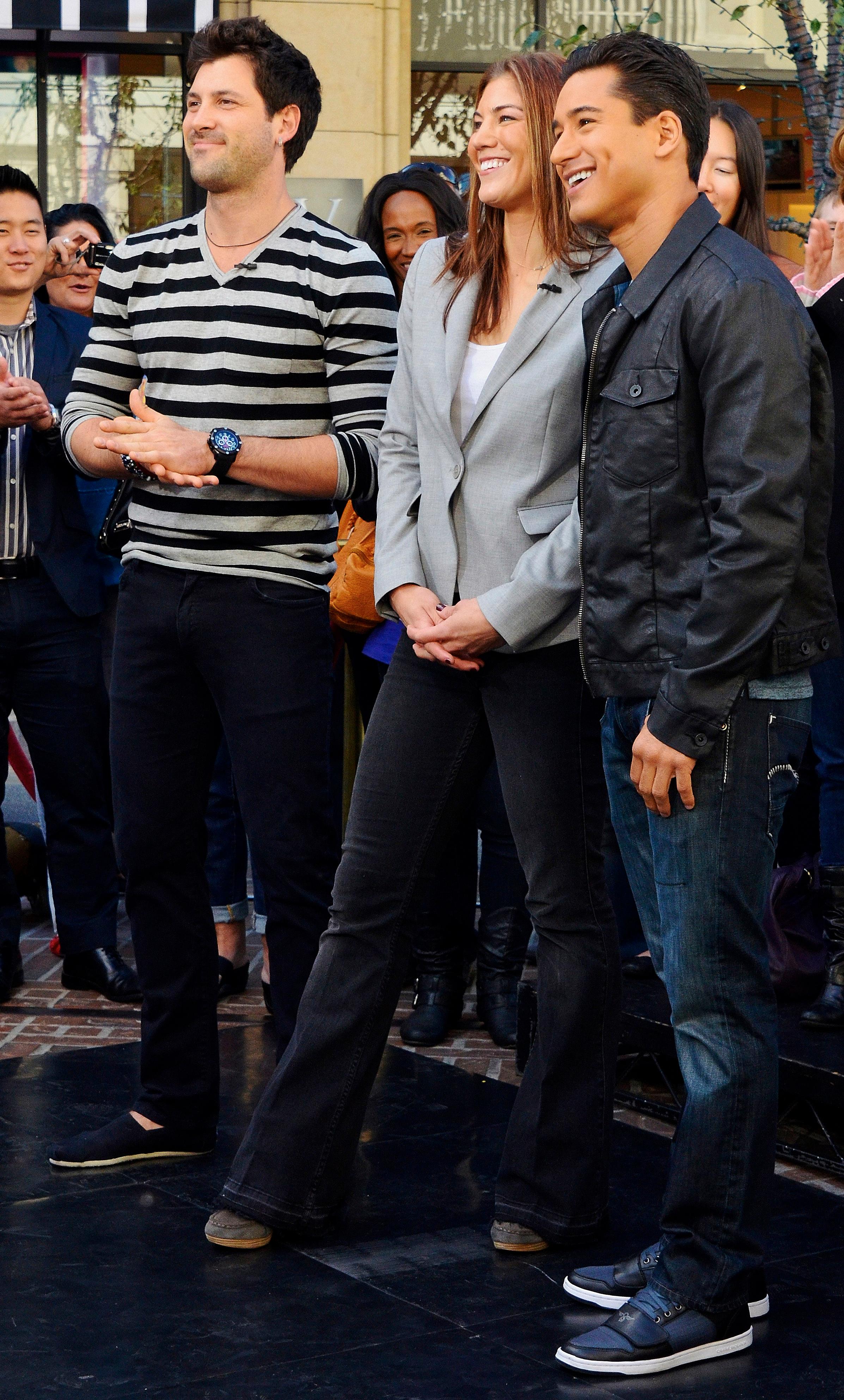 Hope Solo and Maksim Chmerkovskiy talk and dance their way around the Extra set with Mario Lopez at The Grove