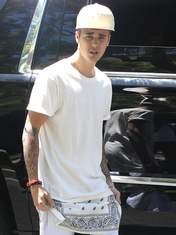 Justin Bieber waves to fans outside his house