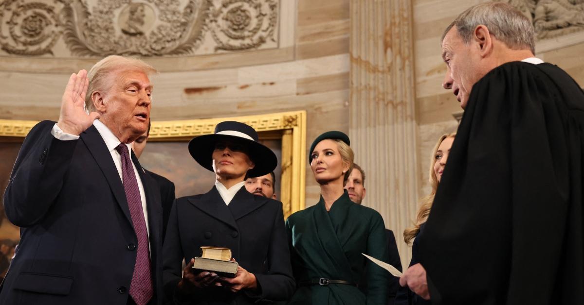 Photo of Donald Trump taking the oath of office near Melania and Ivanka Trump.