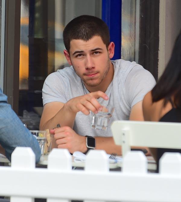 Nick Jonas looks glum as he eats lunch in the West Village