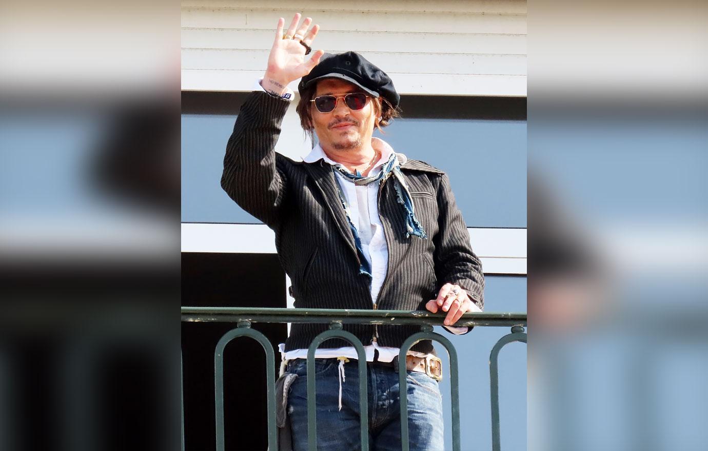 johnny depp waving balcony deauville film festival