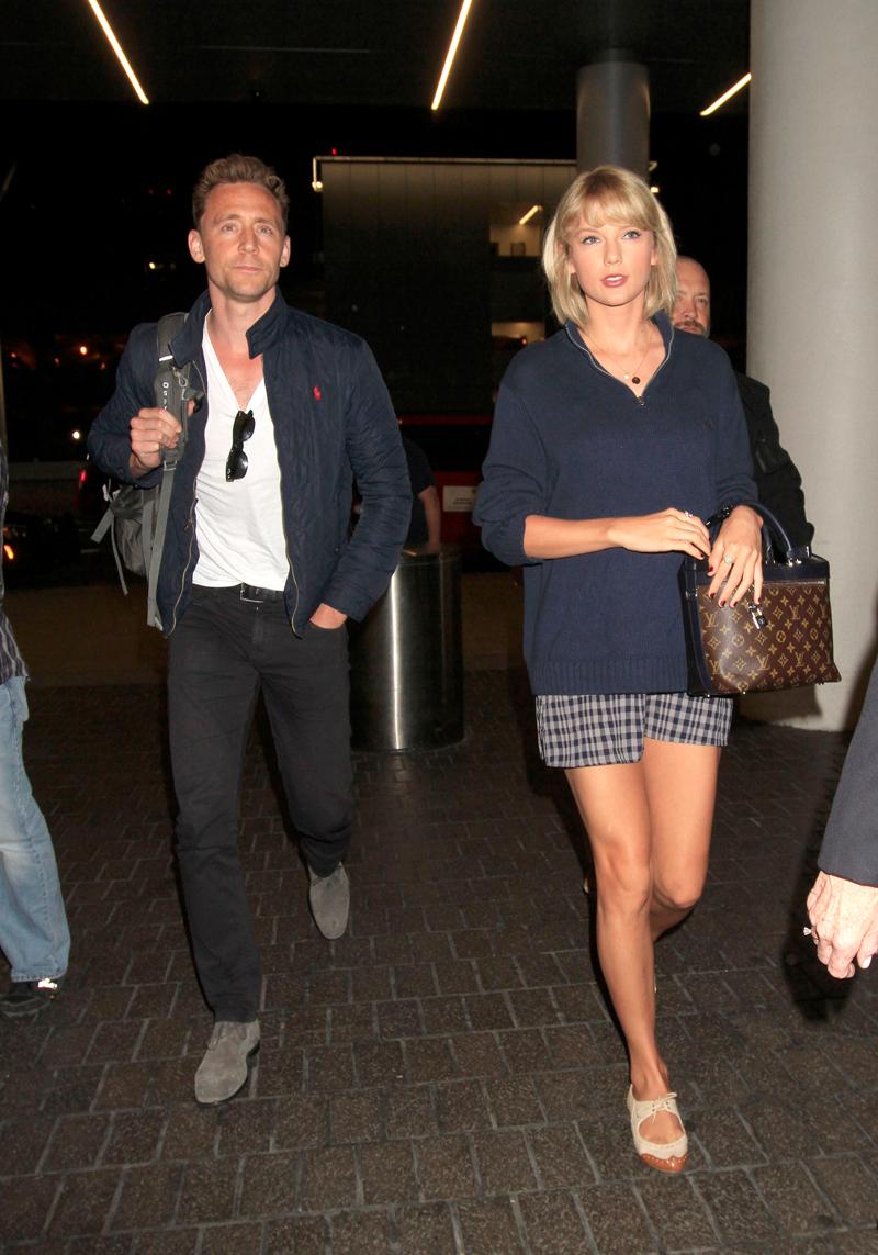 Taylor Swift &amp; Tom Hiddleston continue their world tour as they fly out of Los Angeles surrounded by several bodyguards.  The &#8220;1989&#8221; singer &amp; &#8220;The Avengers&#8221; actor were seen side by side as they caught a flight out of LAX.