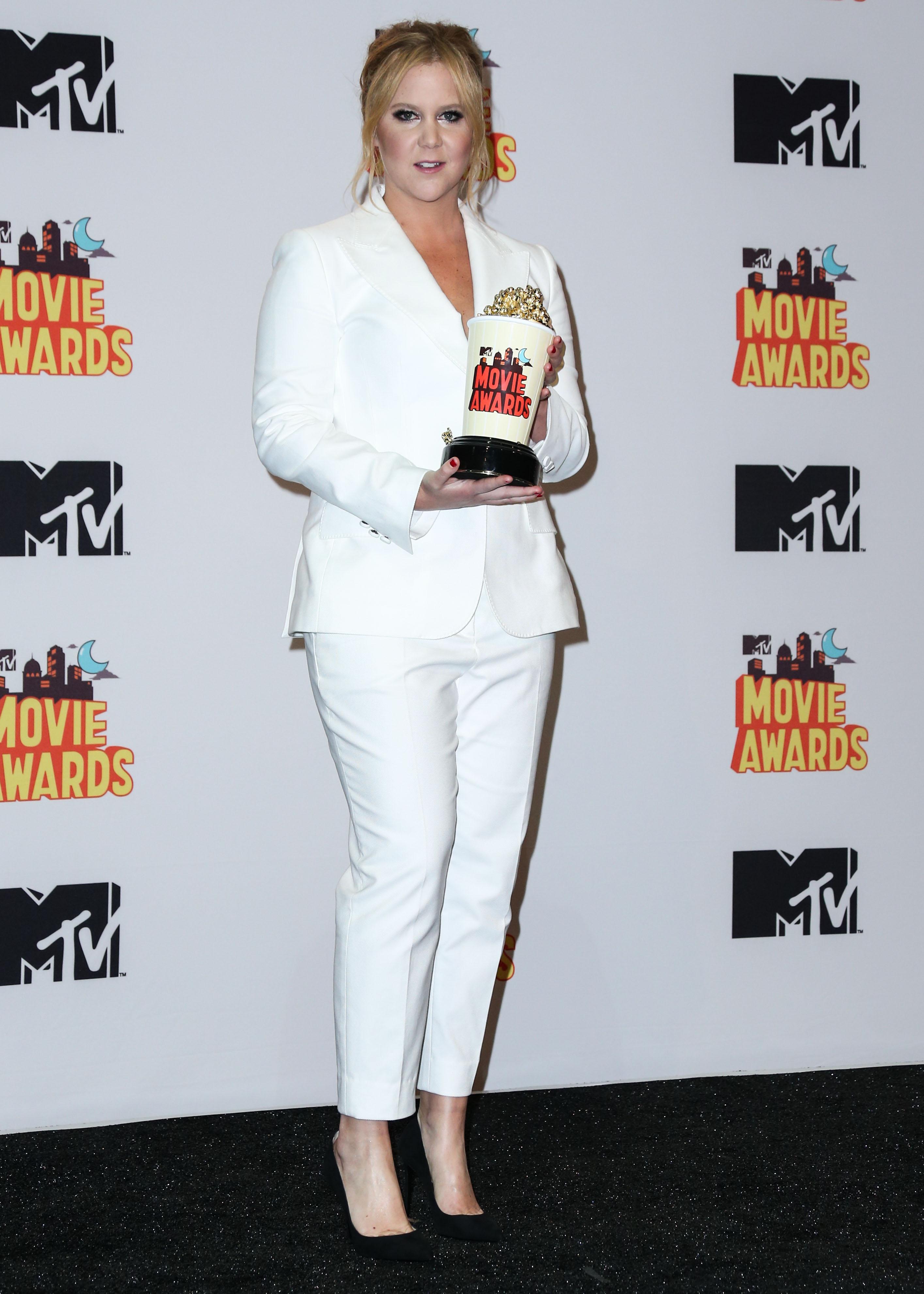 Amy Schumer poses in the press room at the 2015 MTV Movie Awards