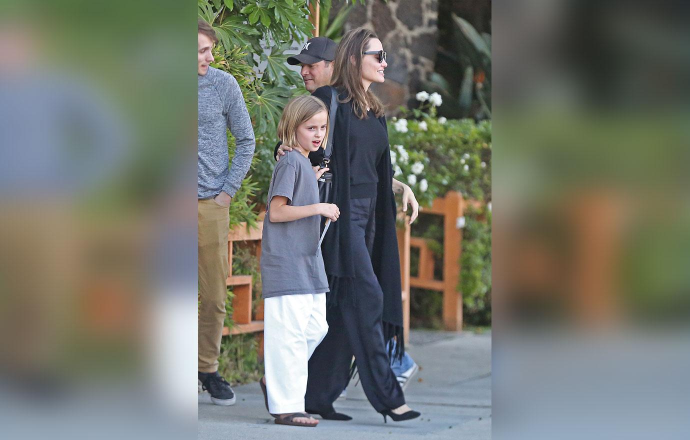 Angelina Jolie is every inch the proud parent as she escorts daughter Vivienne to her karate graduation.