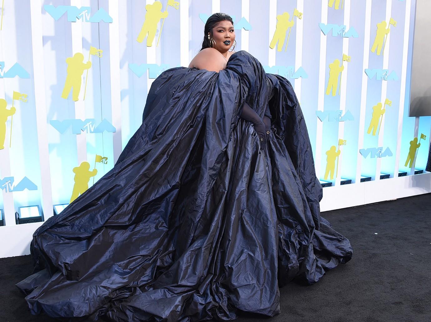 Lizzo's breast spill out as she flaunts her body in fur bikini (photos)