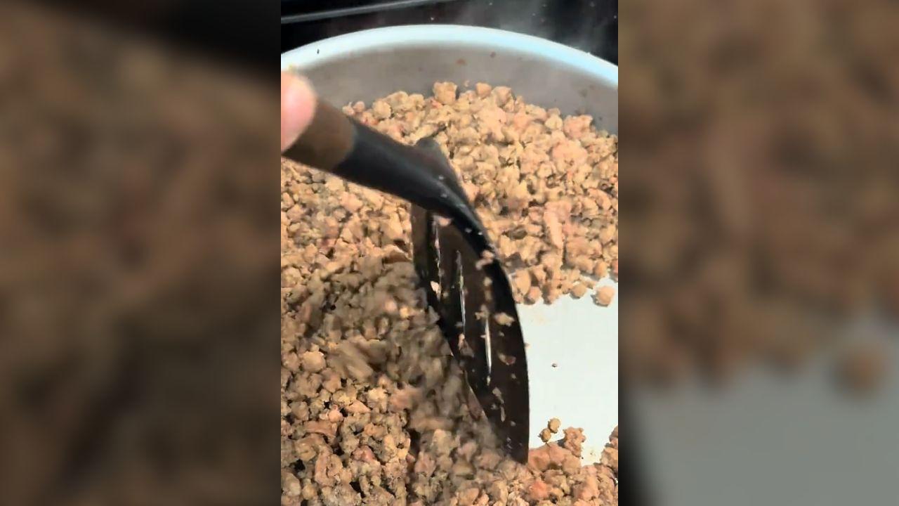 Image of a woman panicked when the ground beef she bought from Sam's Club stayed red no matter how long she cooked it.