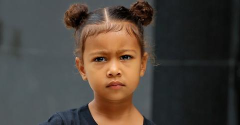 North West, wearing a Supreme t shirt and her hair in knots, leaves Kim Kardashian’s apartment with her nanny in New York City