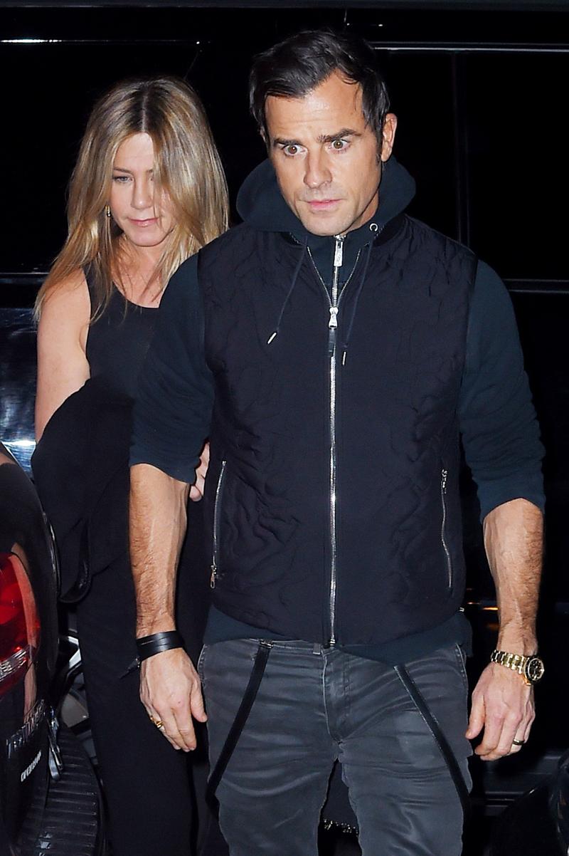 Jennifer Aniston has a small smile as she holds Justin Theroux&#8217;s hand after dinner