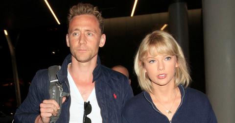 Taylor Swift & Tom Hiddleston continue their world tour as they fly out of Los Angeles surrounded by several bodyguards. The “1989” singer & “The Avengers” actor were seen side by side as they caught a flight out of LAX.