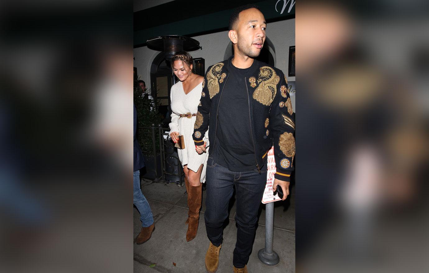 Chrissy Teigen and John Legend hold hands as they leave Madeo restaurant after having a romantic dinner