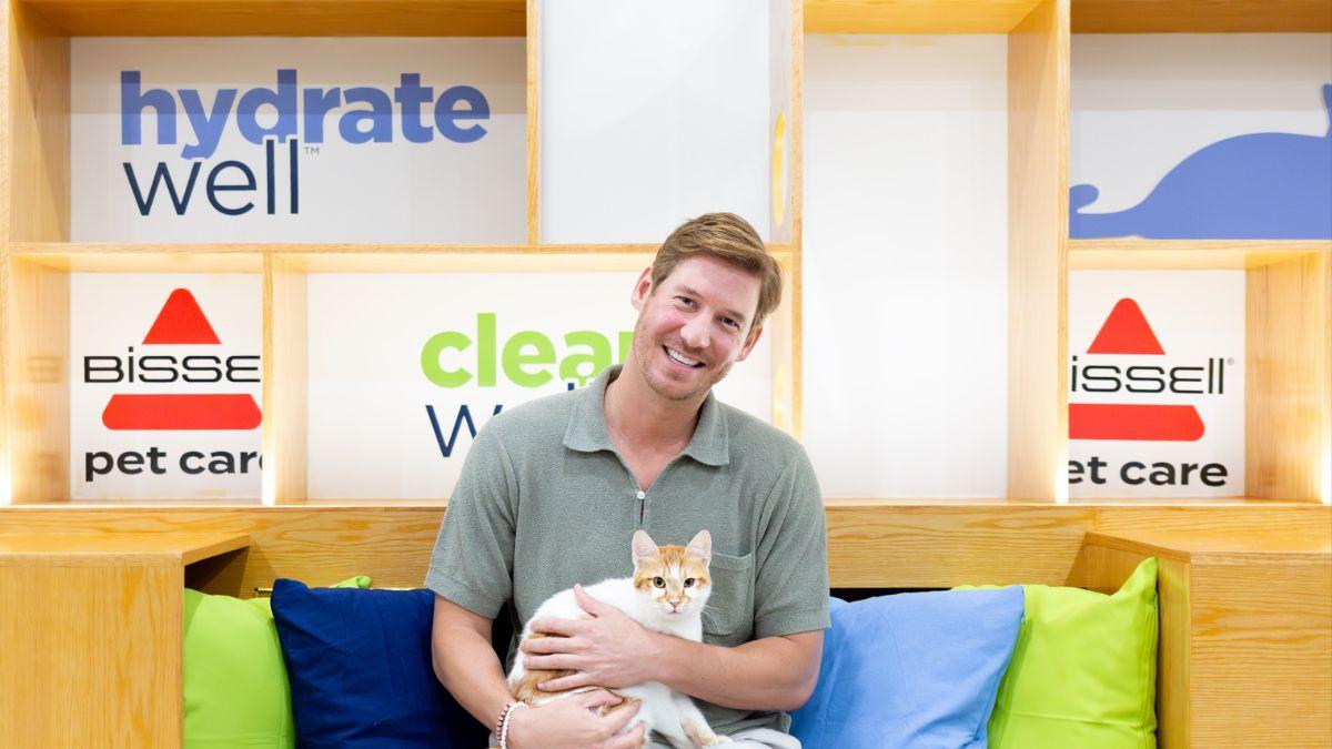 image of Austen Kroll pictured with a cat at the NYC event. 