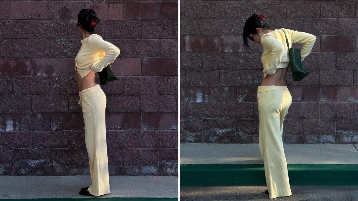 Image of Kendall posed against a building wall in a butter-yellow lounge set.
