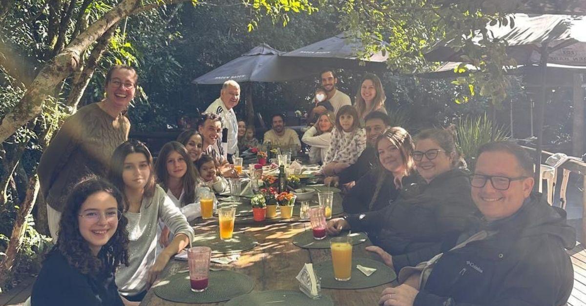image of Joaquim Valente held the baby during the birthday dinner.