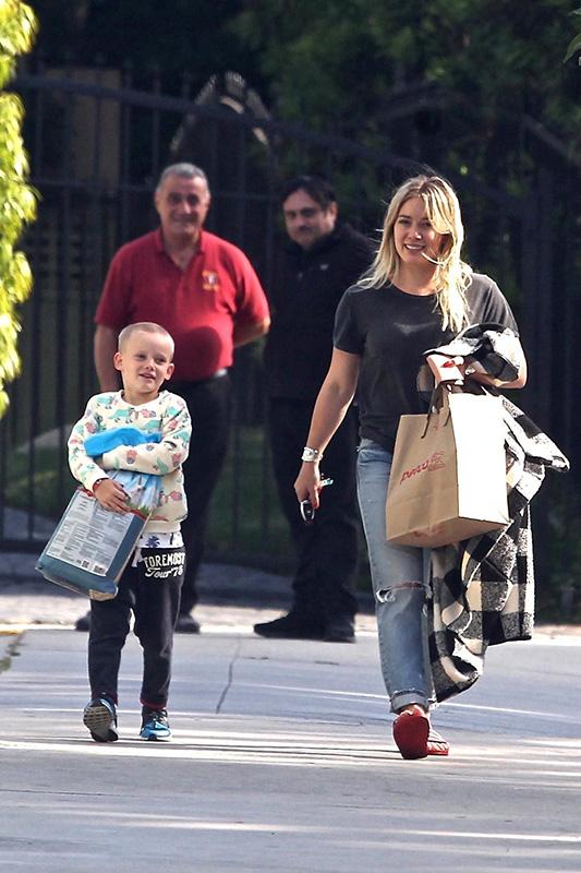 *EXCLUSIVE* Hilary Duff gets some help from Luca carrying the dog food