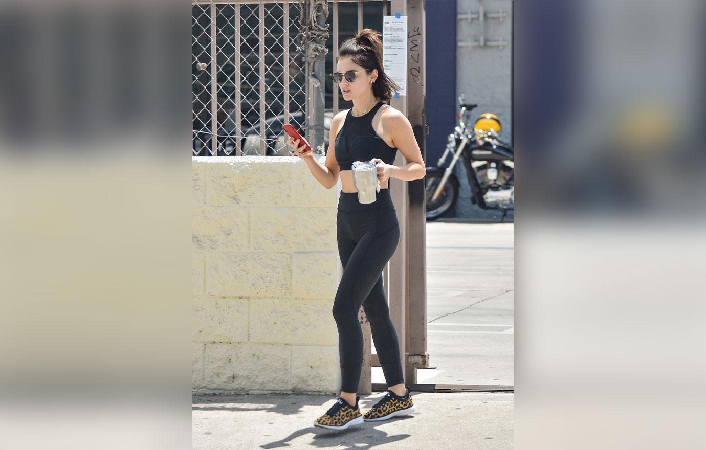 Lucy Hale displays her fit body in a sports bra and leggings as she hits the