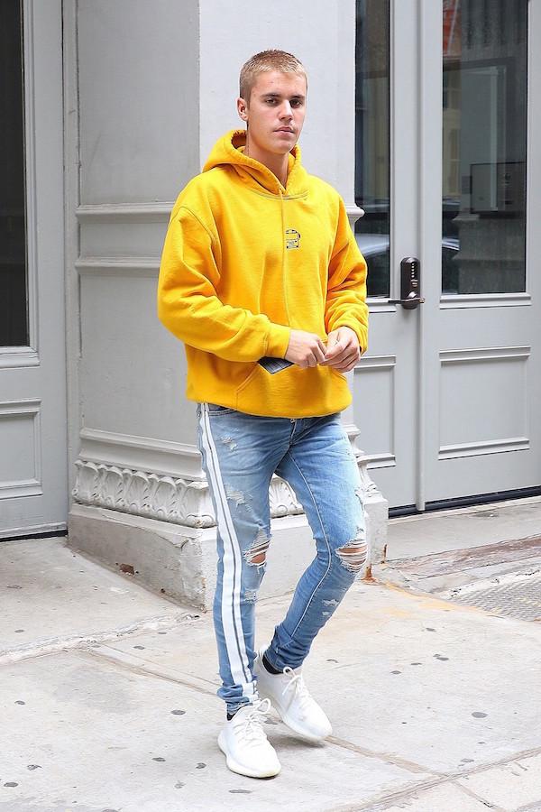 Justin Bieber stands out in a bright yellow hoodie