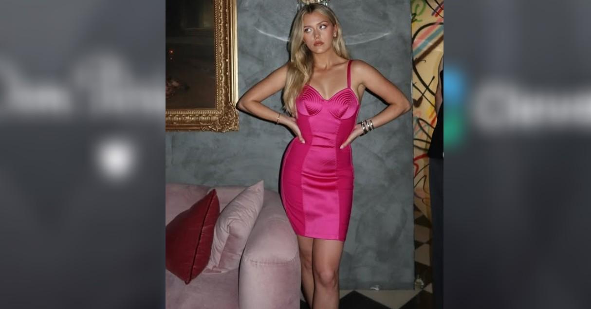 Chloe Marks in a pink dress. 