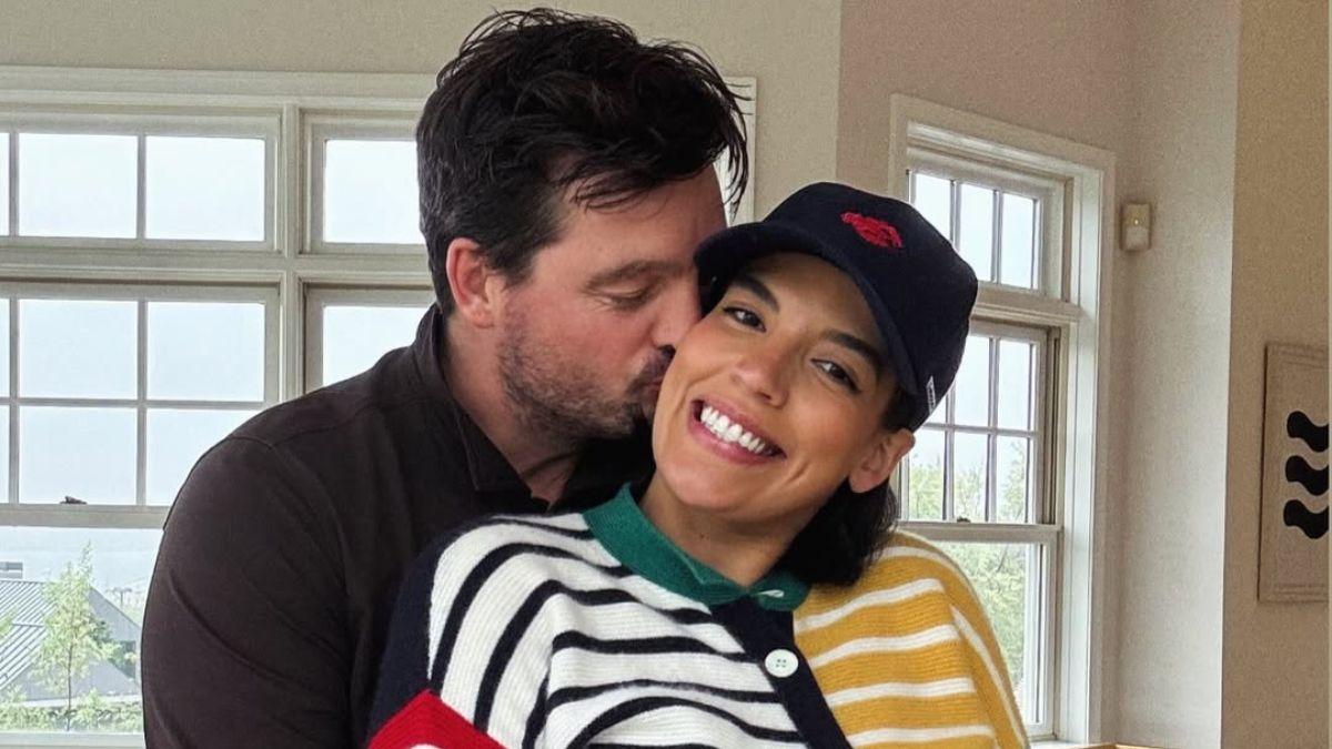 Image of Eoin Heavey plants a kiss on Danielle Olivera as they prepare for parenthood.