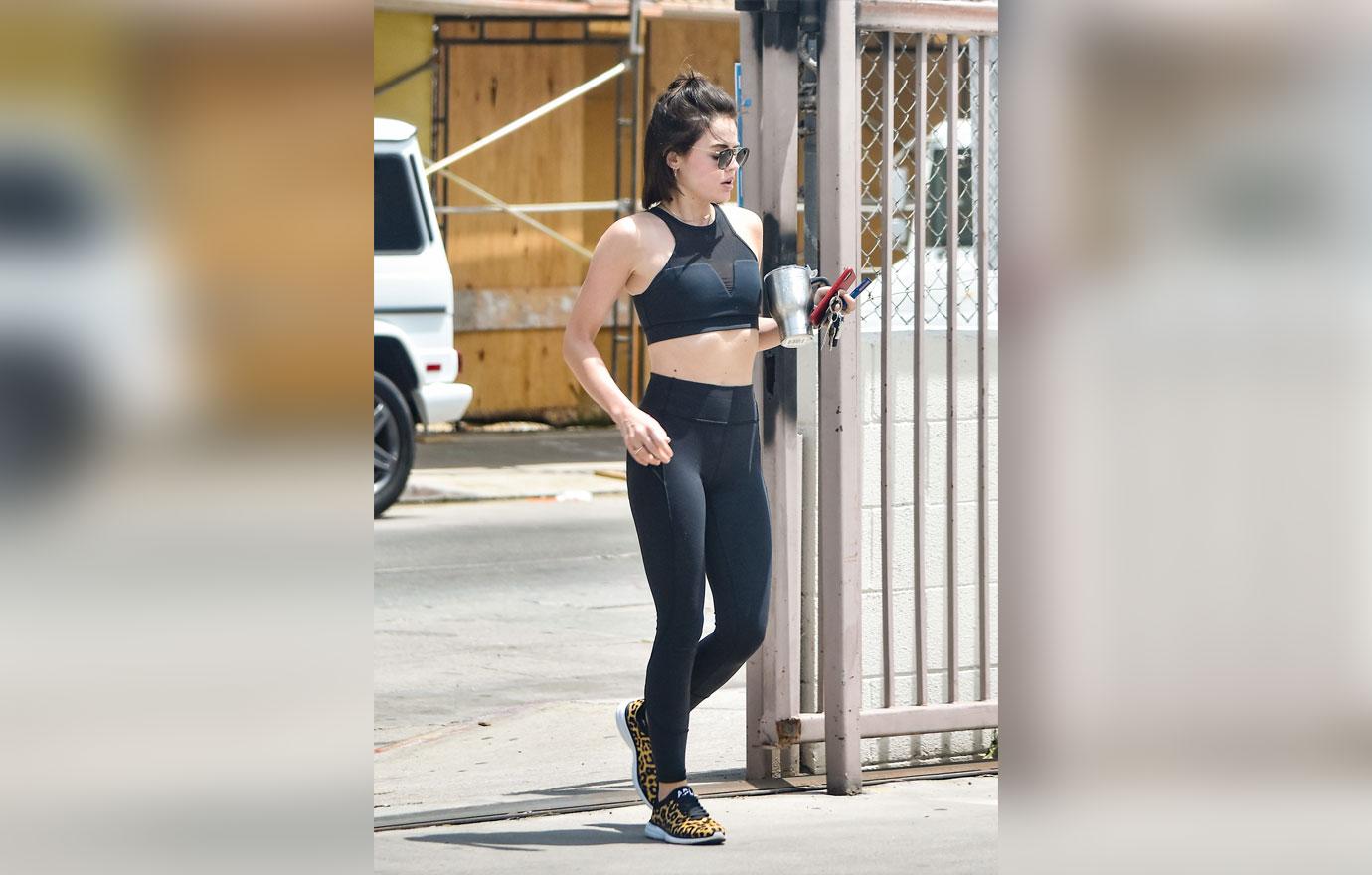 Lucy Hale heads out in a black sports bra and leggings after a