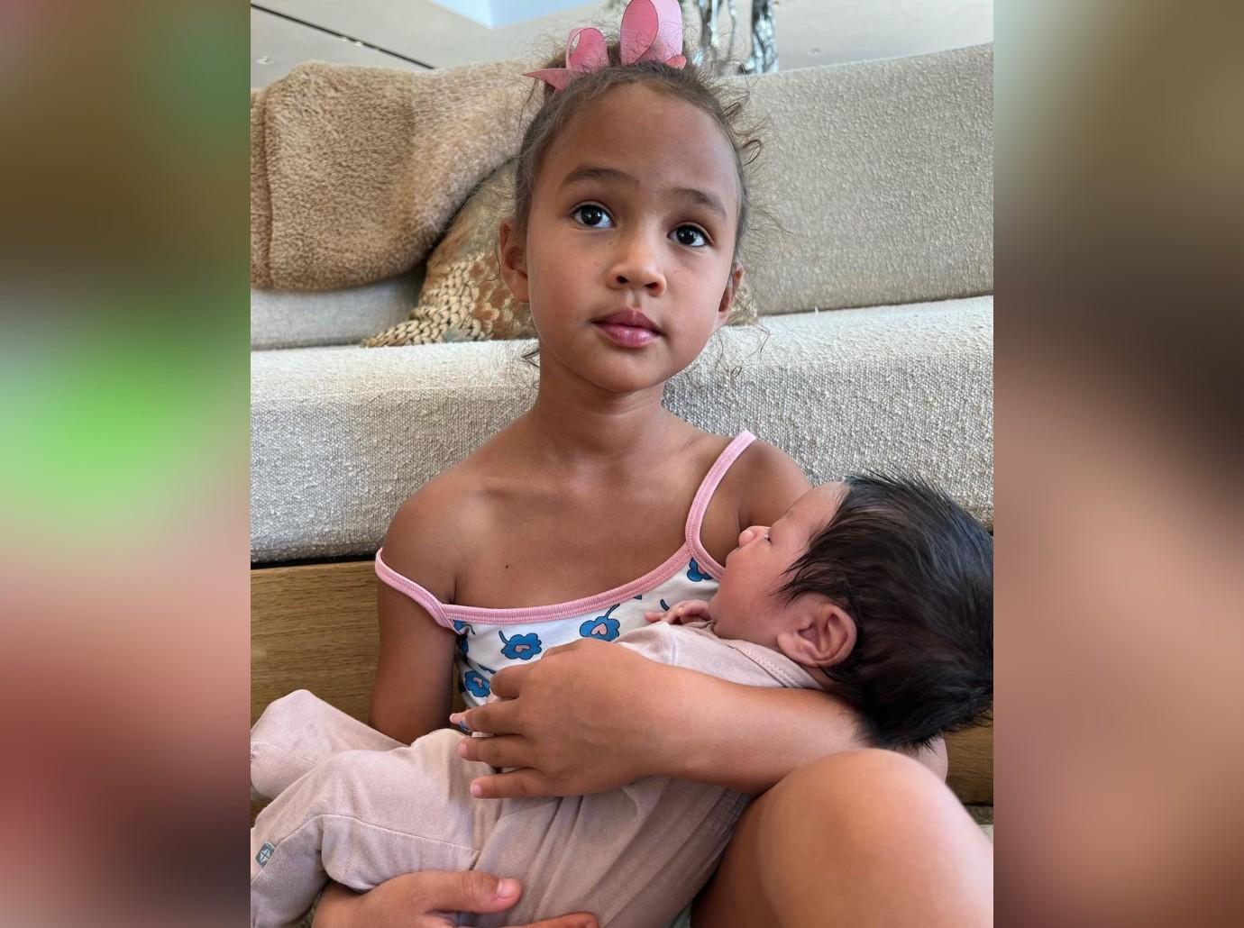 chrissy teigens daughter luna cradles newborn brother family photos