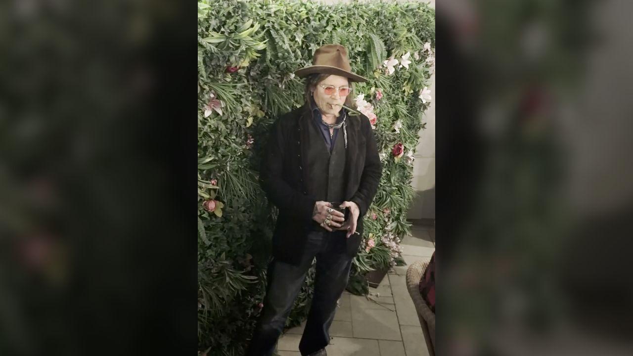 Image of Johnny pulled away with multiple leaves hanging out of his mouth.