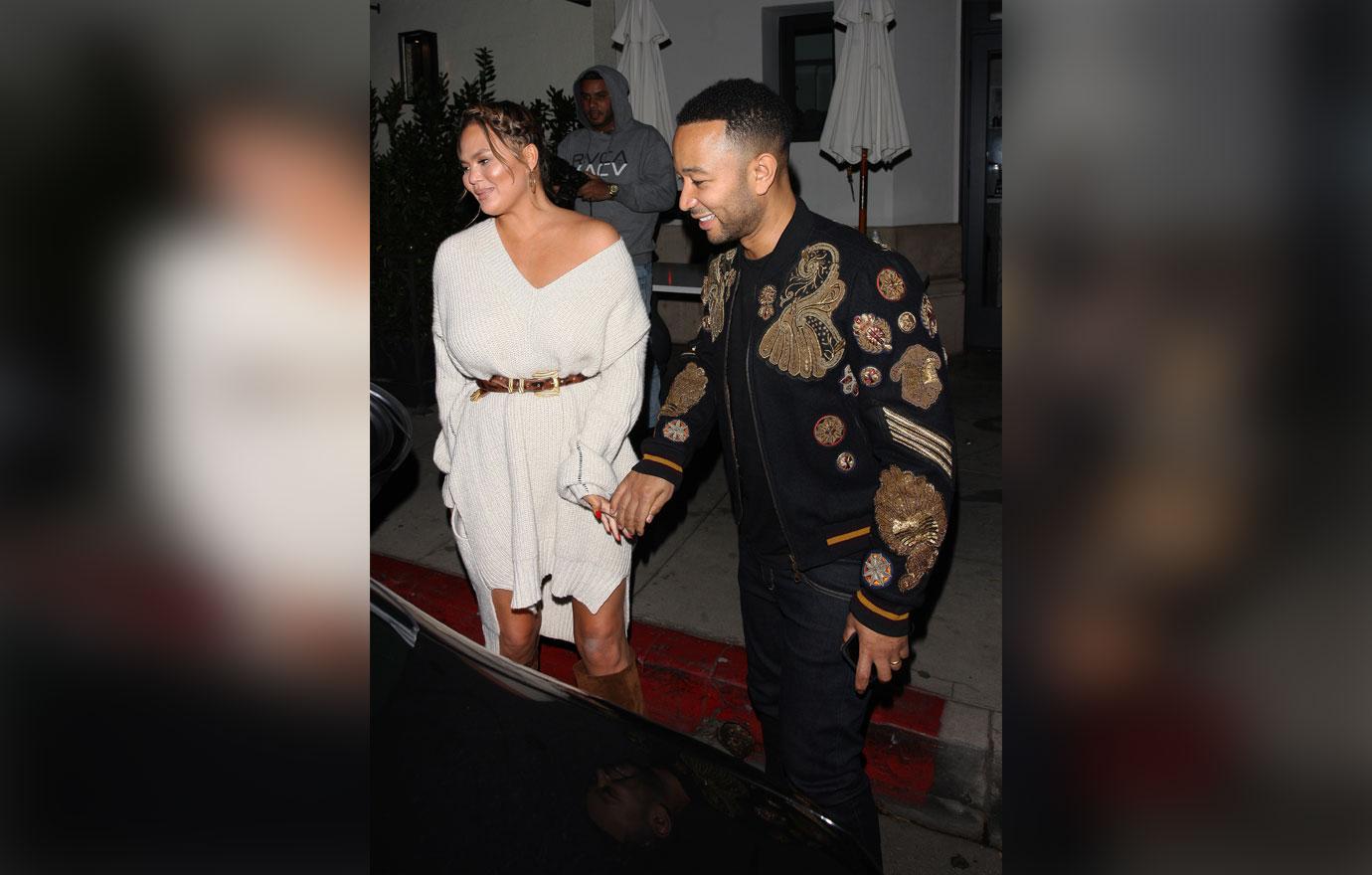 Chrissy Teigen and John Legend hold hands as they leave Madeo restaurant after having a romantic dinner