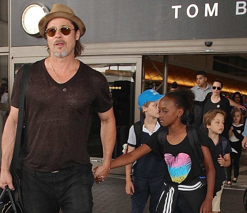 Brad Pitt and Angelina Jolie arriving on a flight at LAX with their children