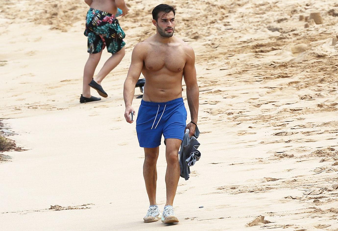 britney spears boyfriend sam asghari takes a solo stroll on the beach while on vacation in maui ok