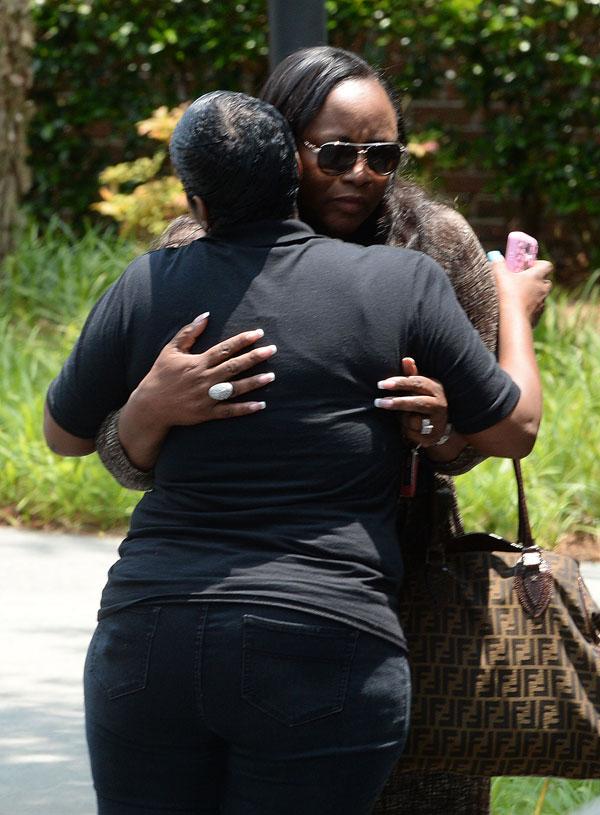 Pat houston tina brown hold hands outside hospice center 06